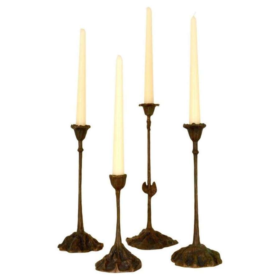 Group of four candle holders on different heights cast bronze in organ